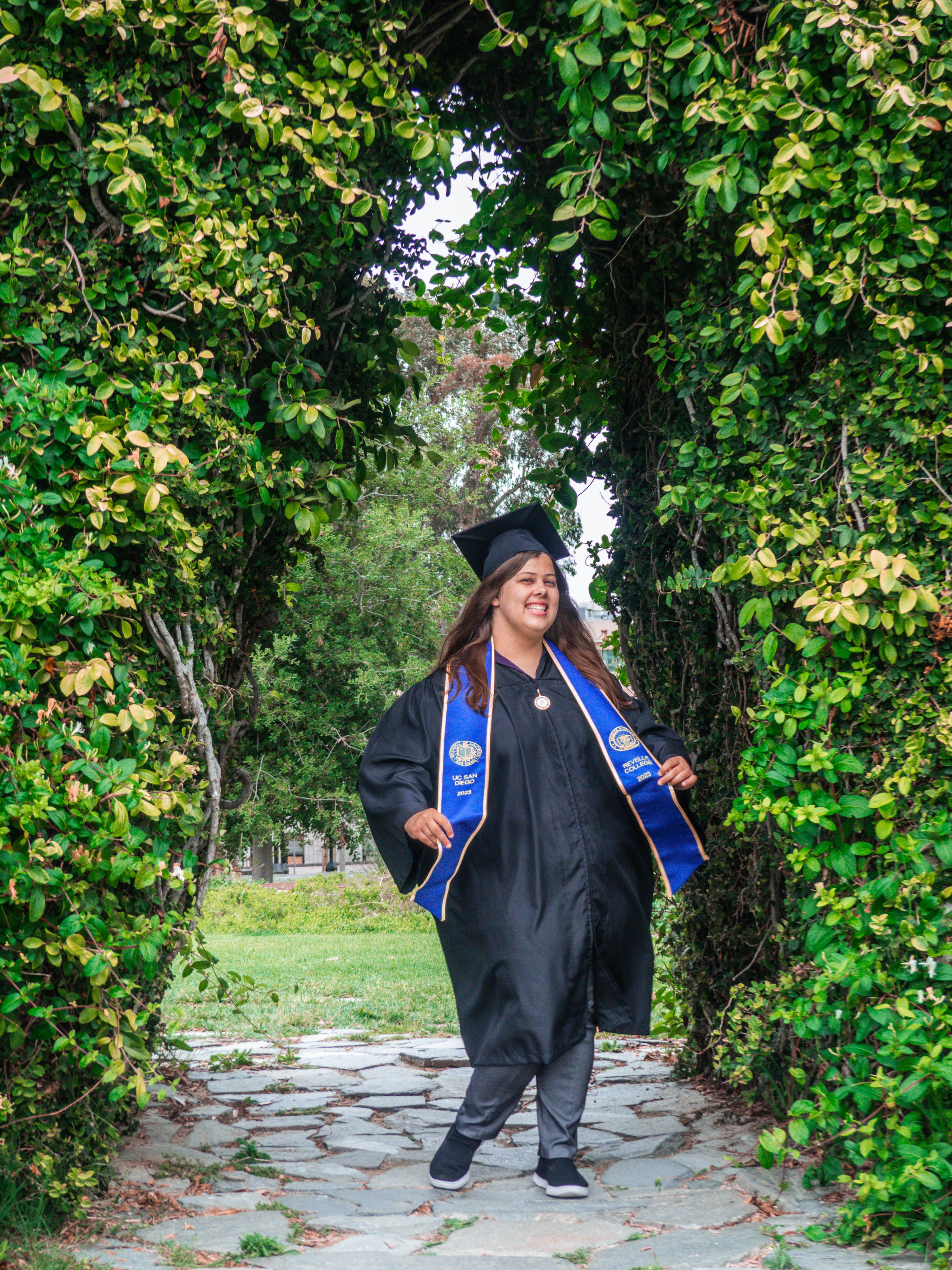 A graduation photo of me underneath the Sun God statue at UC San Diego.