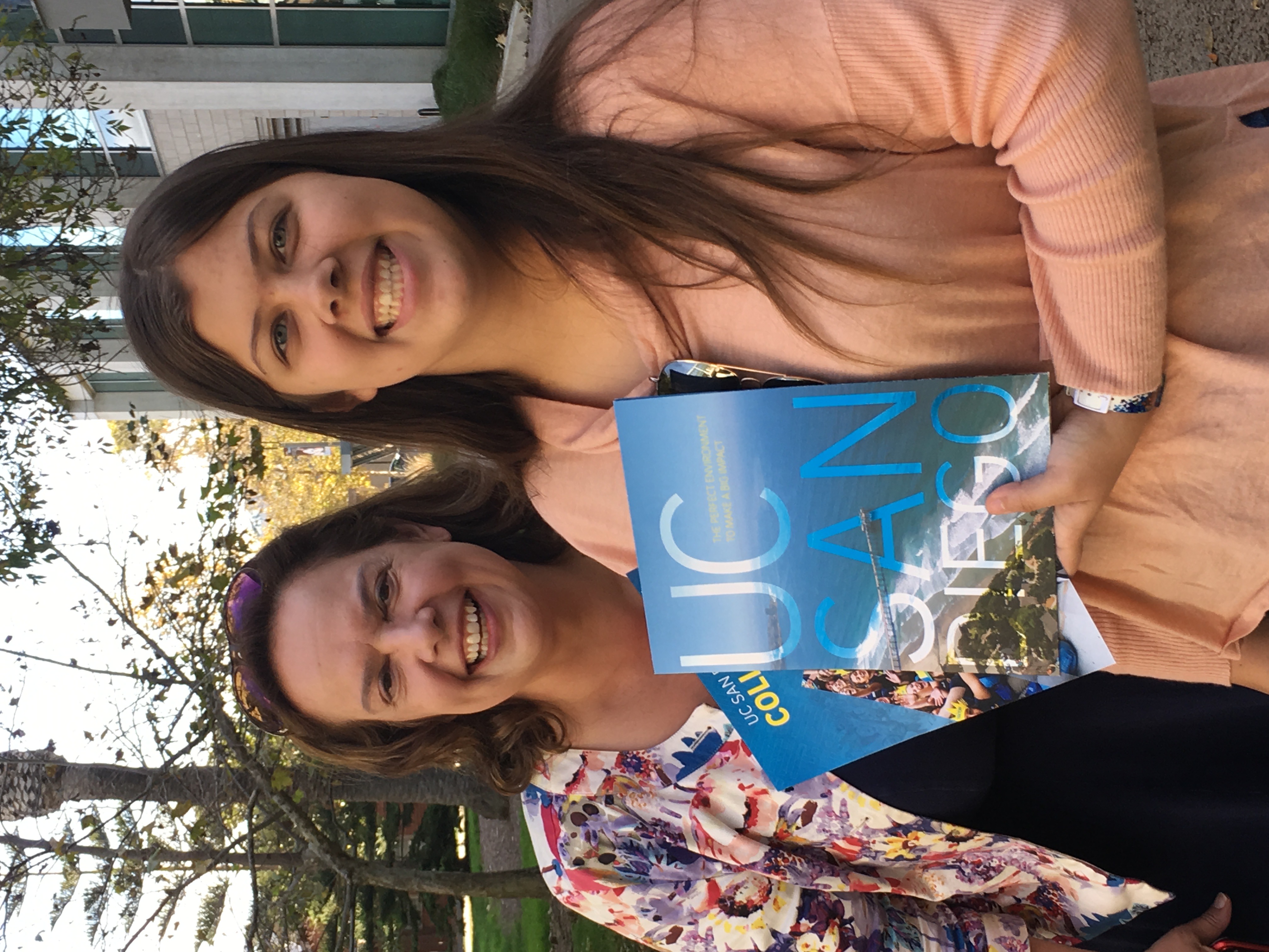 A tour photo of me and my aunt Kerry holding a UC San Diego admit packet and smiling.